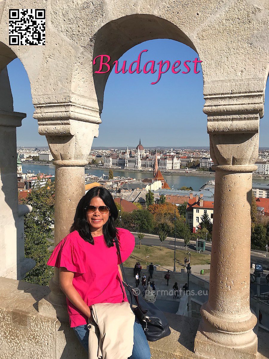 Hungary Budapest view from Halászbástya over the Danube and the Parliament woman in red