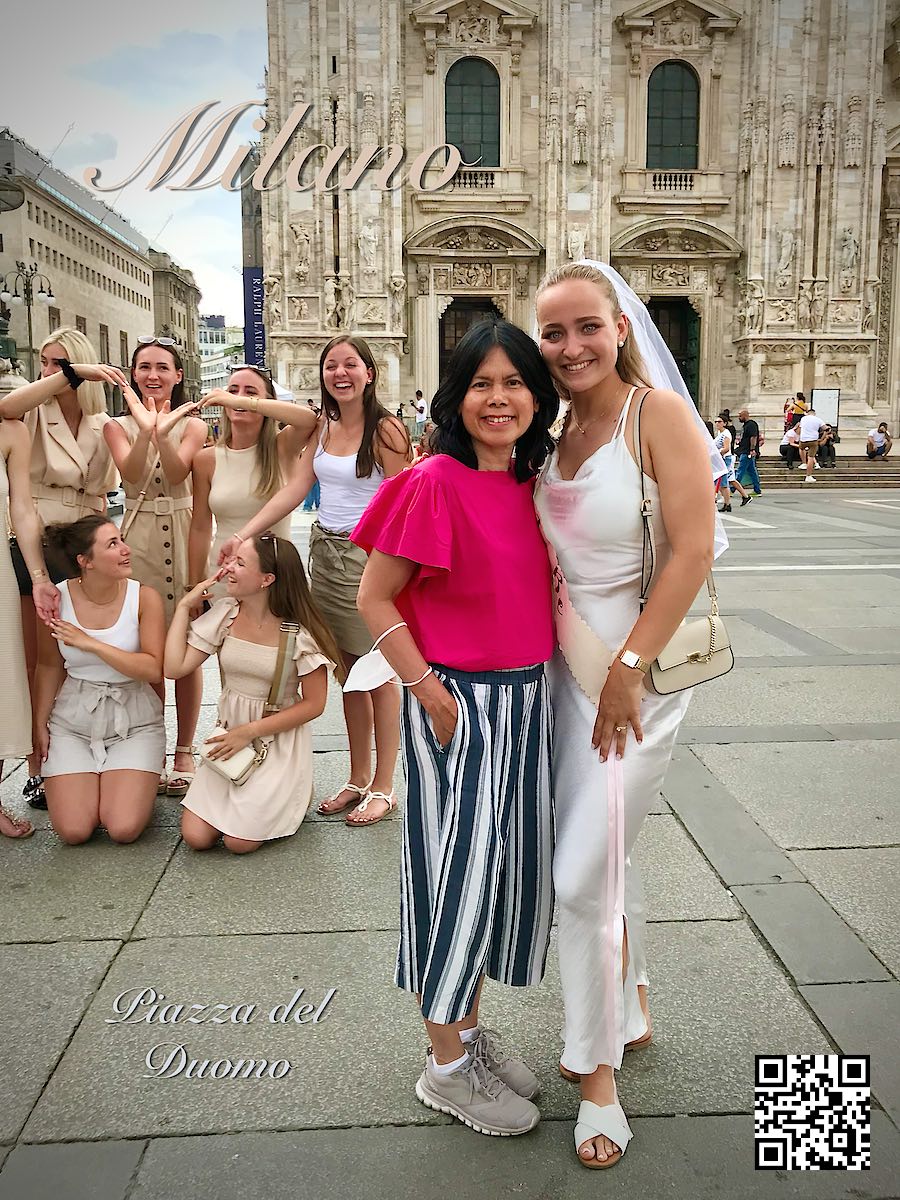 Italy Milano at Piazza del Duomo woman in red next to happy wedding party of girls 