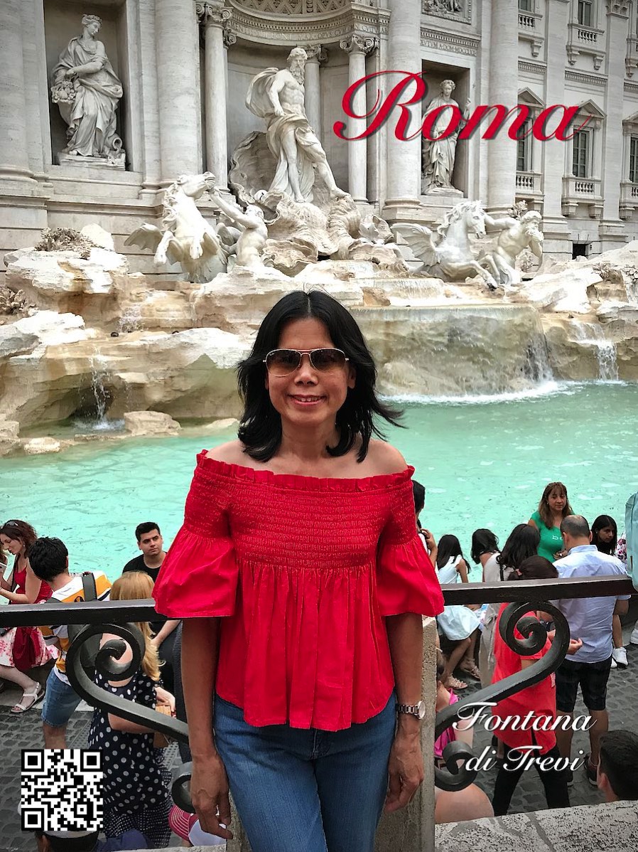 Italy Rome woman in red in front of Fontana di Trevi
