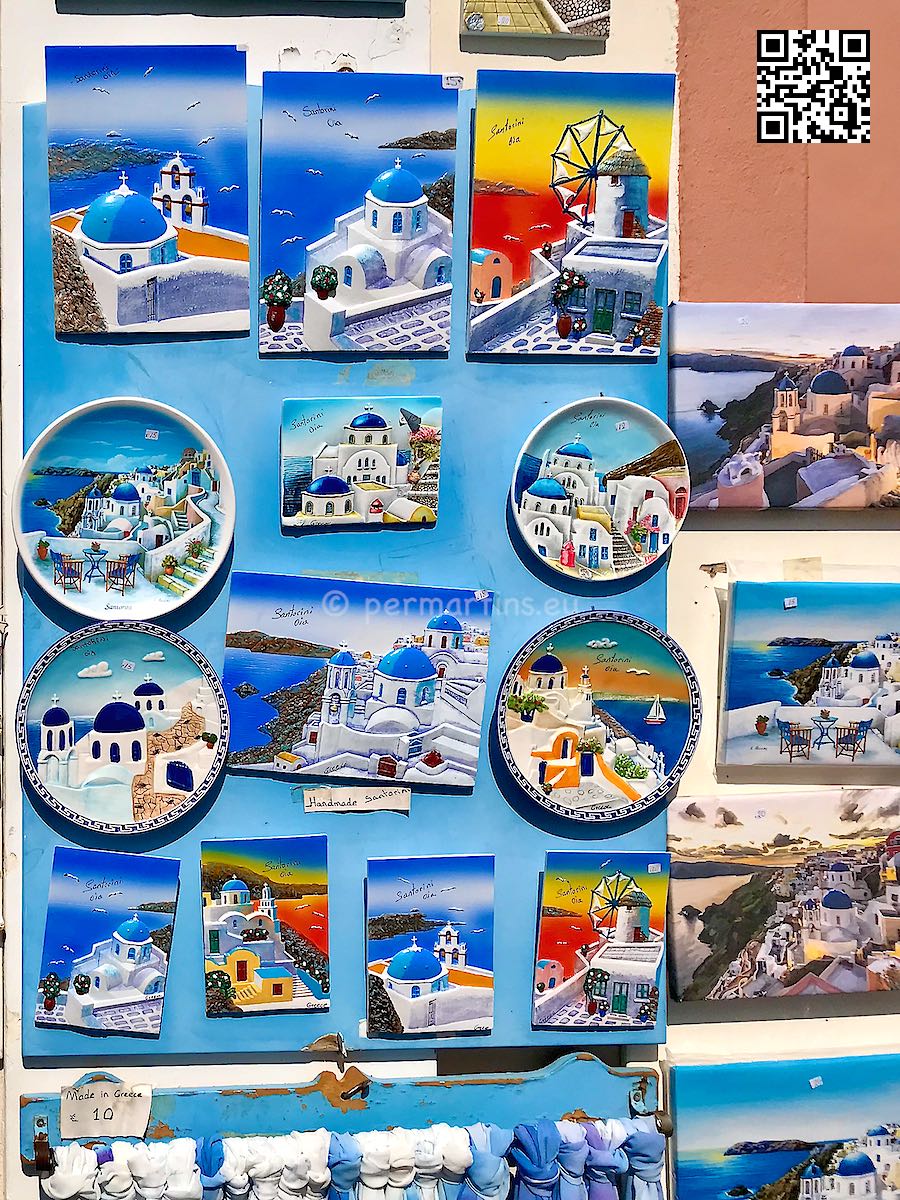 Greece Santorini Oia plates on a wall at a souvenir shop.