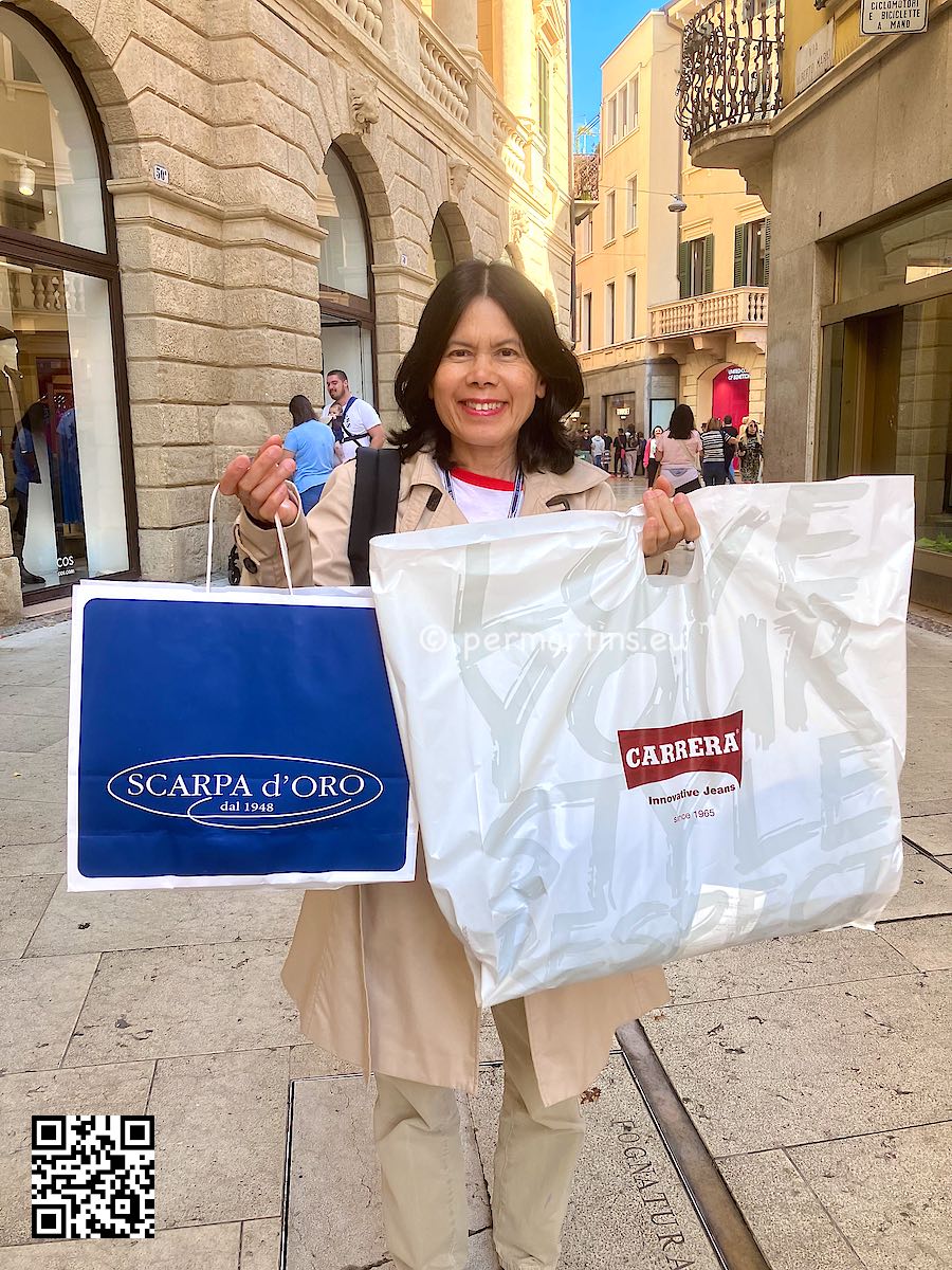Italy Verona woman holding up two shopping bags shoes pants