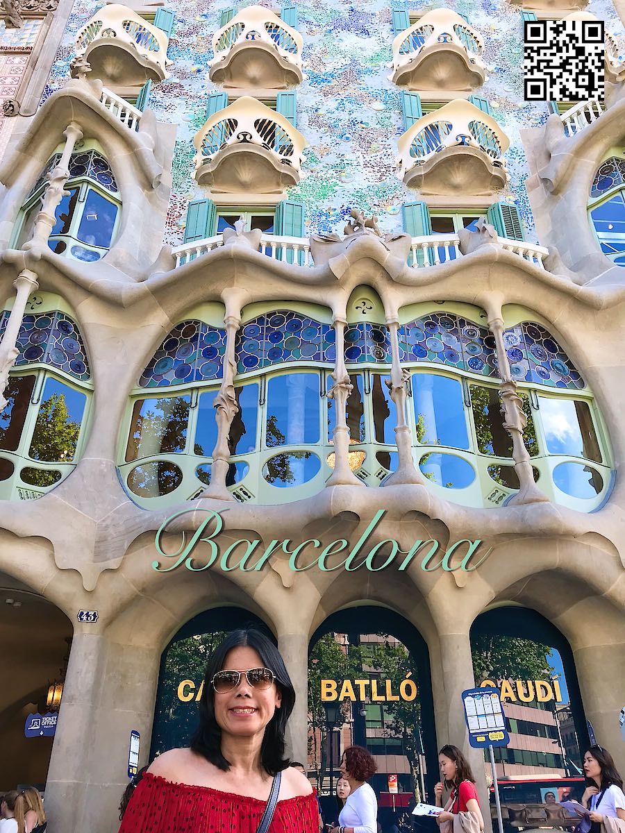 Spain Barcelona woman in red wearing singlasses in front of the building Casa Batlló by Gaudí